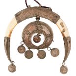 A 19TH CENTURY EASTERN EUROPEAN BRIDLE ORNAMENT FOR A HORSE, the crescent shaped body formed from