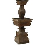 AN ANTIQUE CHINESE BRONZE THREE TIER STAND, with geometric and stylized foliate decoration over all.