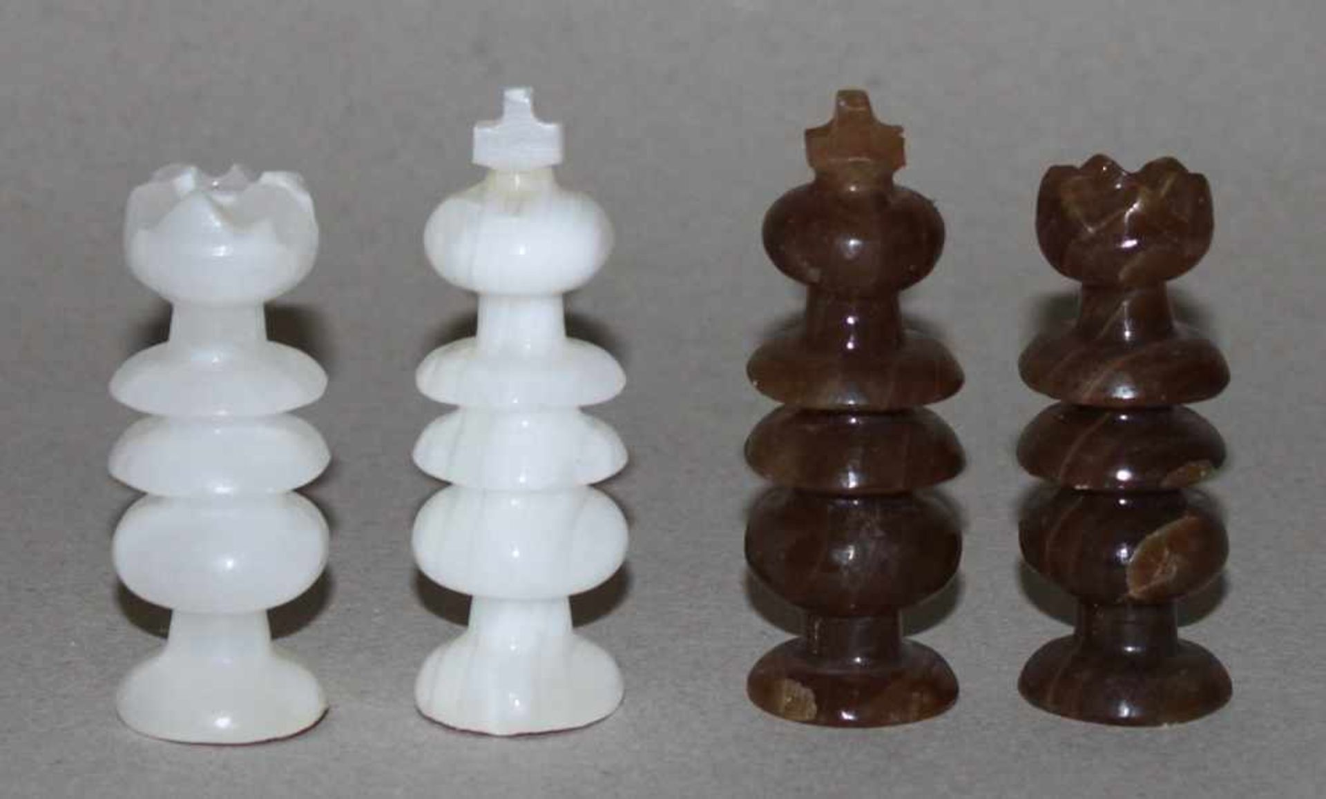 Europa. Schachfiguren aus Marmor.Die eine Partei in Braun, die andere Weiß. Produktion aus der 2.