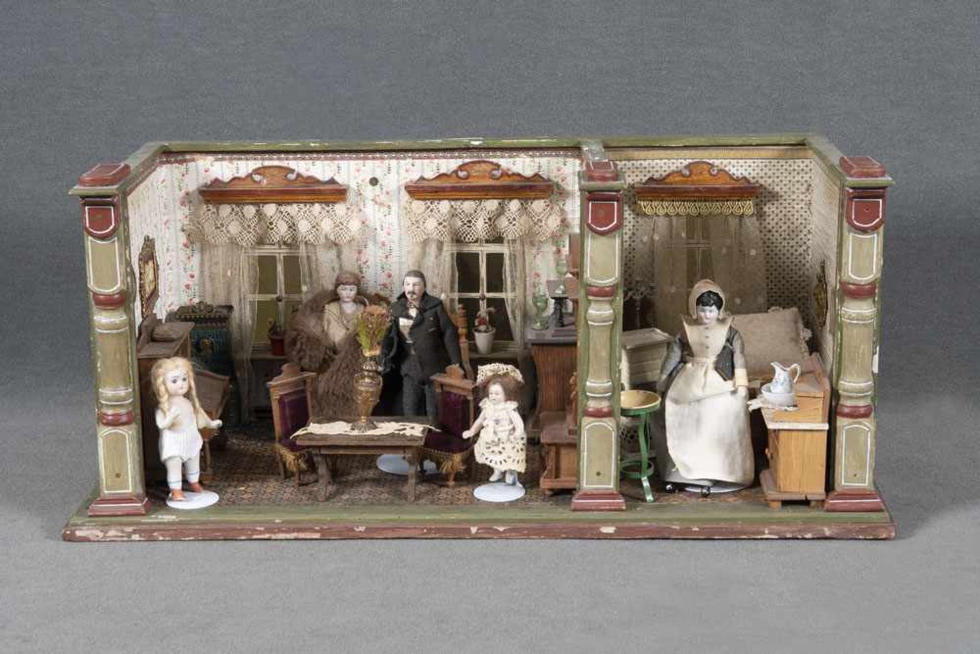 Puppenstube mit zwei Zimmern. Deutsch 20. Jh. Mit Möbeln, Bildern, Ofen, Puppen mit Porzellankörpern