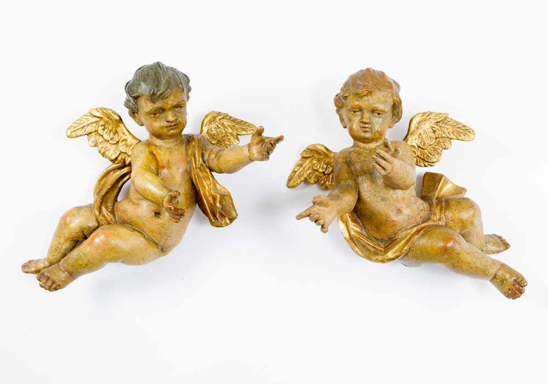 Pair of flying angels, in Baroque manner, wood carved with original colours and gilding; a pair.