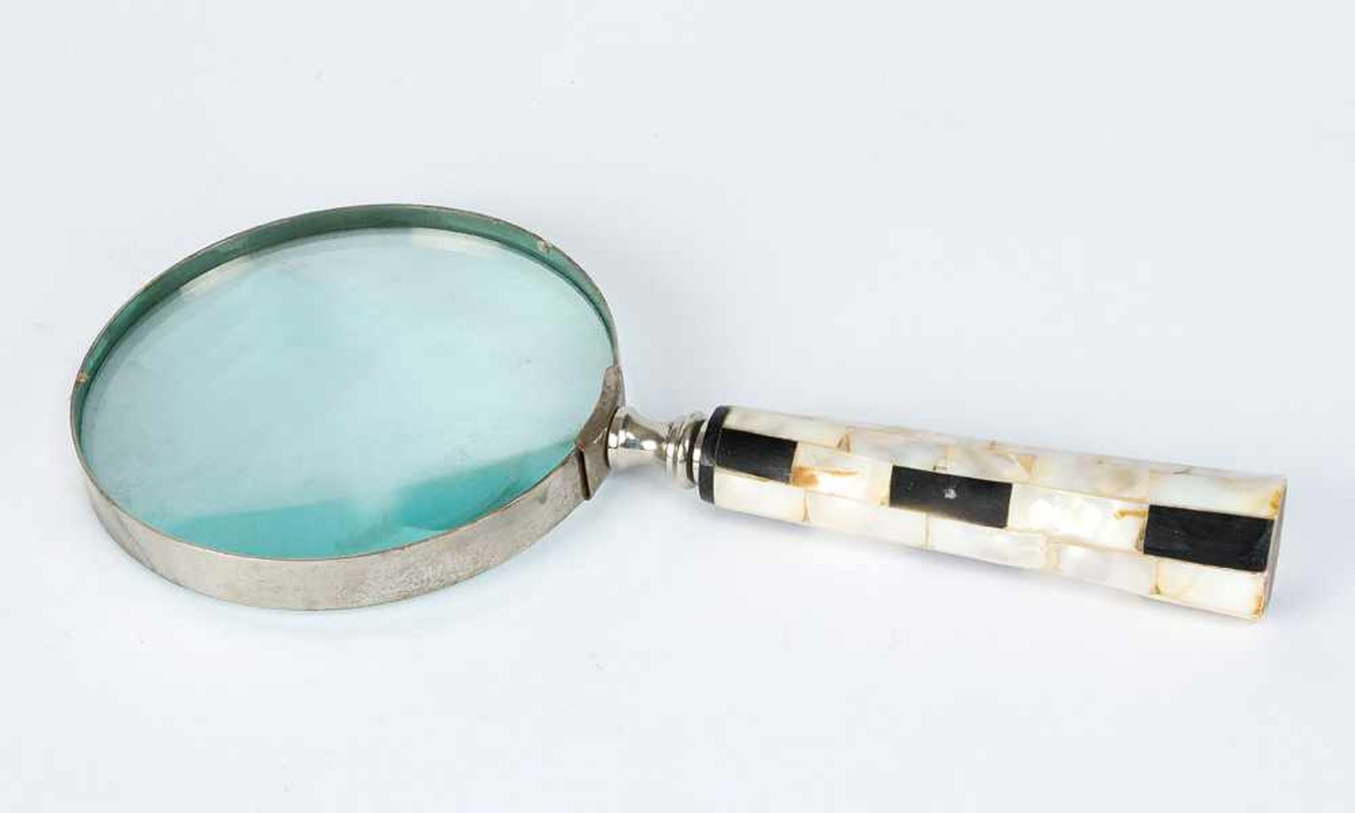 Magnifier, round glass lense with chromed framed and mother of pearl and ebonised hand grip.