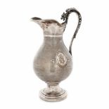 Centrally decorated carafe with monogrammed medallion and griffin-shaped handle