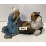 A CHINESE STONEWARE FIGURE GROUP OF TWO GAMES PLAYERS