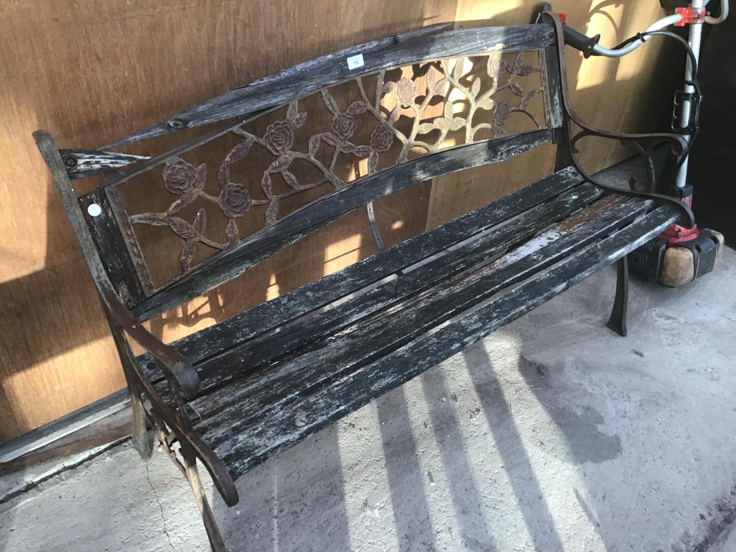 A WOODEN BENCH WITH CAST IRON ENDS AND A CAST IRON ROSE DESIGN BACK - Image 2 of 2