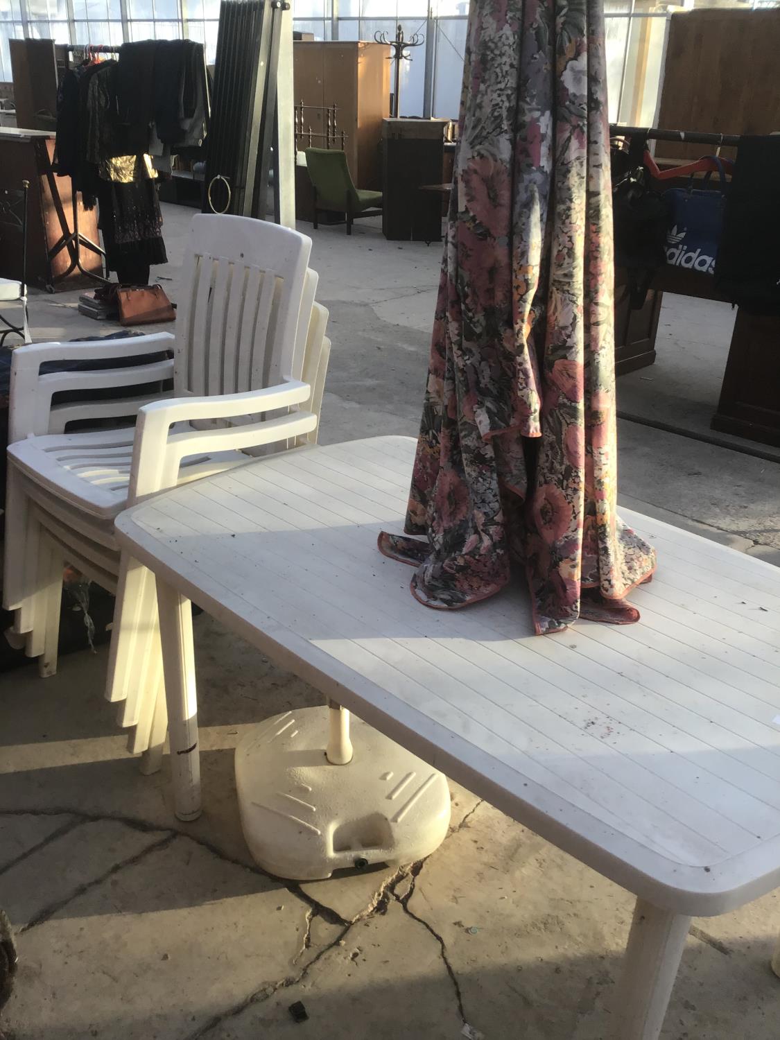 A WHITE PLASTIC GARDEN TABLE WITH FOUR MATCHING CHAIRS, A FLORAL PARASOL AND BASE