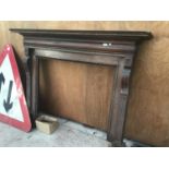 AN EDWARDIAN OAK FIRE SURROUND