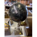 A BLACK AND SILVER DESIGN DESK GLOBE ON STAINLESS STEEL BASE