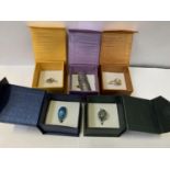 A COLLECTION OF FIVE BOXED DRESS RINGS