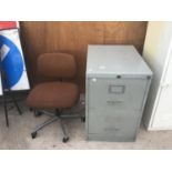 A HOWDEN TWO DOOR METAL FILING CABINET AND AN OFFICE CHAIR