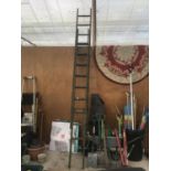 A VINTAGE WOODEN TWENTY RUNG TWO SECTION LADDER