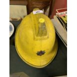 A GREATER MANCHESTER FIREMAN'S YELLOW HELMET