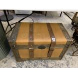 A CANVAS AND LEATHER EFFECT TRUNK SUITCASE