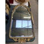 A LARGE GILT FRAMED MIRROR