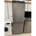 A SILVER FRIDGE FREEZER IN WORKING ORDER (DENT ON FRONT AND SOME SHELVES BEEN REPAIRED)