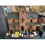 A LARGE DOLLS HOUSE WITH VARIOUS FURNISHING ACCESSORIES