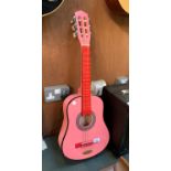 A SMALL CHILD'S PINK ACOUSTIC GUITAR