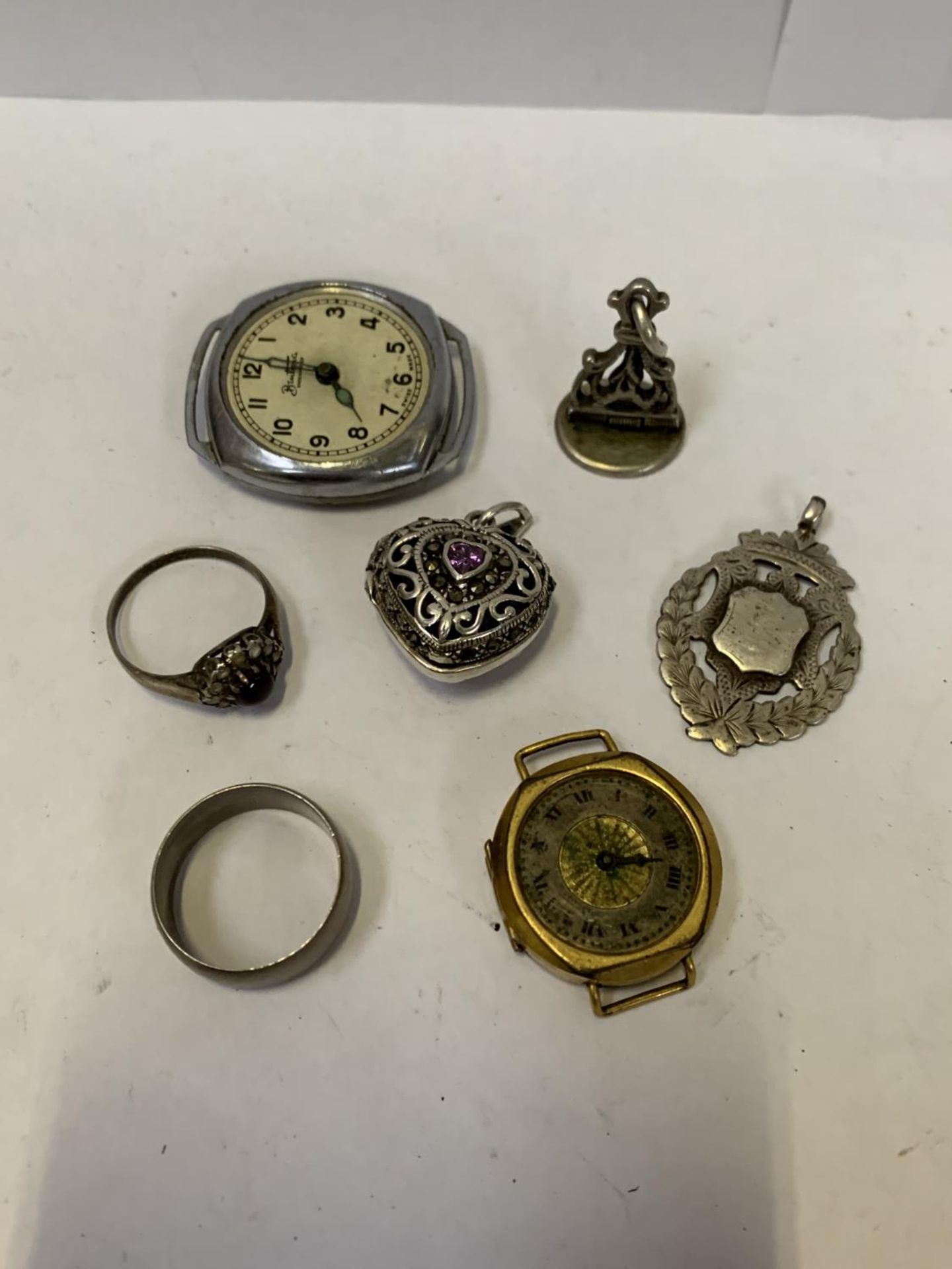 A MIXED COLLECTION OF ITEMS- TWO SILVER RINGS, A LOCKET, TWO FOBS AND TWO WATCH FACES - Image 2 of 2