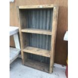 A RUSTIC WOODEN SHELVING UNIT WITH CORRUGATED SHEET BACK