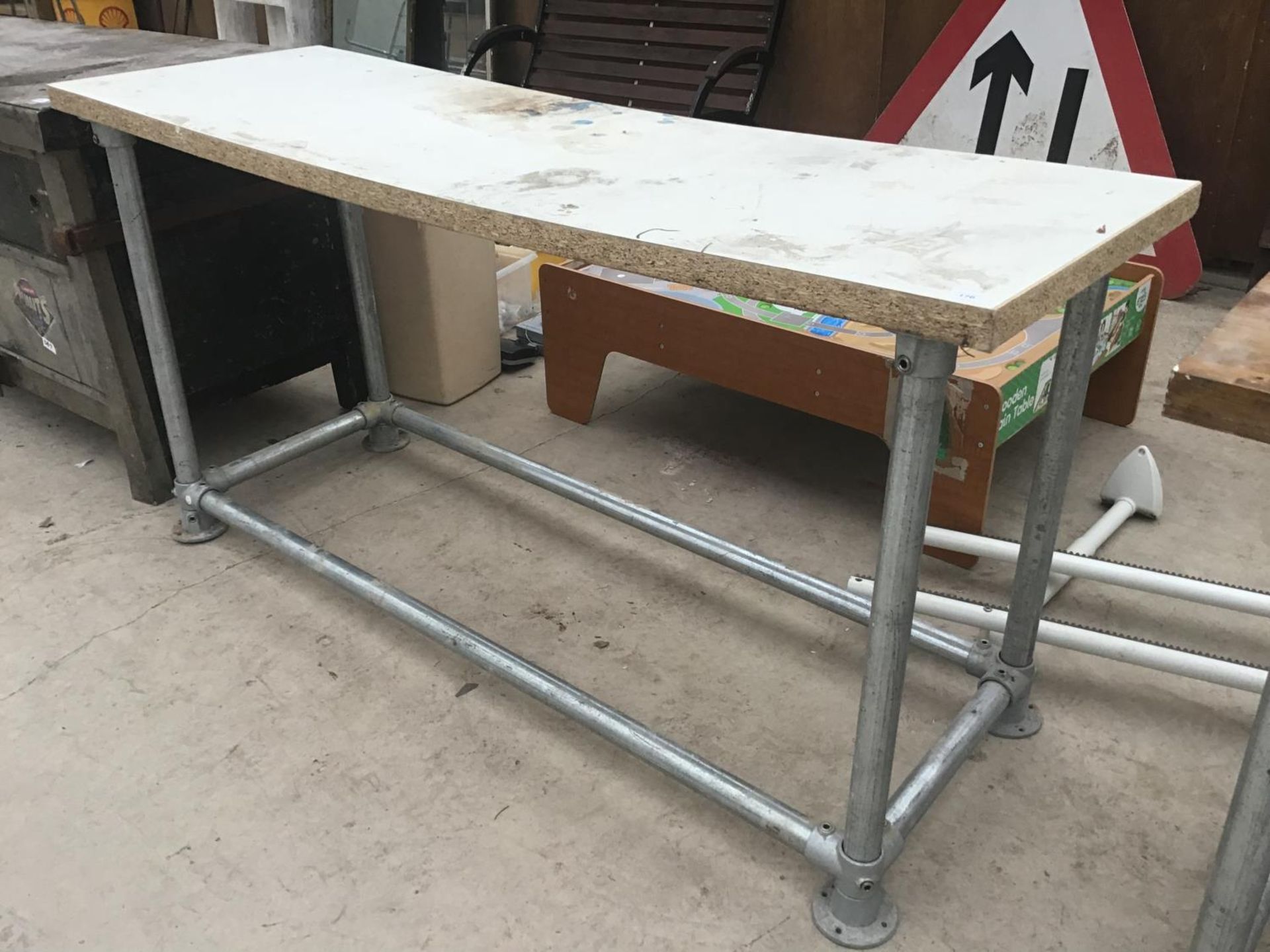 A FORMICA TABLE TOP ON SCAFFOLDING SUPPORTS