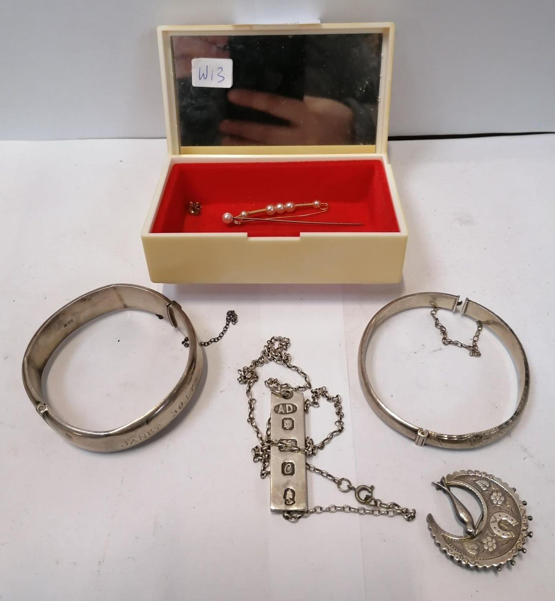 FOUR SILVER JEWELLERY ITEMS - SILVER BANGLES, SILVER BROOCH AND SILVER INGOT NECKLACE