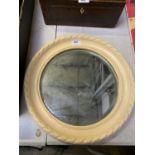 A CREAM CIRCULAR FRAMED MIRROR