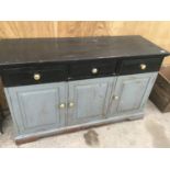 A VINTAGE PAINTED PINE SIDEBOARD WITH THREE SHORT DRAWERS AND THREE DOORS