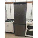 A SILVER FRIDGE FREEZER IN WORKING ORDER (DENT ON FRONT AND SOME SHELVES BEEN REPAIRED)