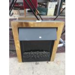 A COAL EFFECT ELECTRIC FIRE WITH BRASS SURROUND IN WORKING ORDER
