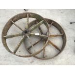 A PAIR OF SEVEN SPOKE 20 INCH IRON WHEELS