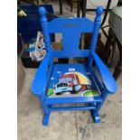 A BLUE PAINTED WOODEN CHILD'S ROCKING CHAIR WITH TRUCK DESIGN