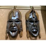 A PAIR OF WOODEN TRIBAL STYLE MASKS