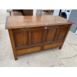 A 19TH CENTURY OAK MULE CHEST WITH HINGED TOP PANELLED FRONT AND TWO LOWER DRAWERS