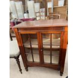 A MAHOGANY CABINET WITH TWO GLAZED PANEL DOORS