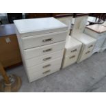 A WHITE CHEST OF FIVE DRAWERS AND TWO BEDSIDE CABINETS