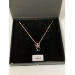 A BOXED SILVER NECKLACE WITH BUNNY PEDANT