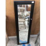 A MIRROR FRONTED TALL KEY/STORAGE CABINET WITH KEY