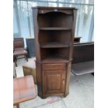 AN OAK CORNER CUPBOARD WITH LOWER DOOR AND UPPER SHELVING