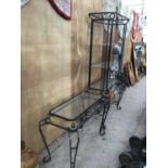 A HEAVY WROUGHT IRON DISPLAY UNIT WITH THREE GLASS SHELVES AND A MATCHING TABLE WITH GLASS TOP. UNIT