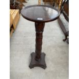 A MAHOGANY TORCHERE ON CENTRE ACANTHUS LEAF DECORATED COLUMN AND PEDESTAL BASE