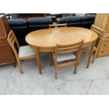 AN OAK EXTENDING DINING TABLE AND FOUR CHAIRS