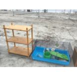 A LARGE INDOOR PET CAGE WTH ACCESSORIES AND A PINE THREE SHELF UNIT