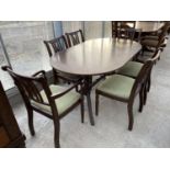 A MAHOGANY EXTENDING DINING TABLE OF TWIN PEDESTAL SUPPORTS WITH FOUR DINING CHAIRS AND TWO CARVERS