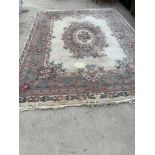 A LARGE PATTERNED RUG (SOME MOTH DAMAGE)