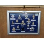 A FRAMED COLLECTION OF ASSORTED REGIMENT BADGES