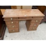 A PINE DESK WITH NINE DRAWERS