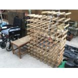 A VERY LARGE WOODEN WINE RACK FOR AT LEAST EIGHTY BOTTLES AND A BAMBOO STYLE TABLE