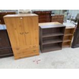 A PINE EFFECT TALLBOY WITH TWO DOORS AND TWO DRAWERS AND TWO BOOKSHELVES