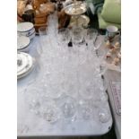 A GOOD COLLECTION OF CUT GLASS WINE AND FURTHER DRINKING GLASSES AND CERAMIC BIRD MODEL