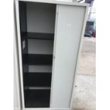 A METAL STORAGE CABINET WITH SLIDING DOOR AND INNER SHELVING